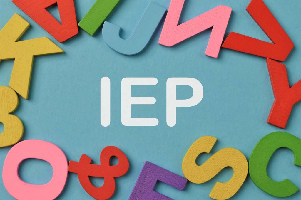 Different letters of the alphabet in a circle around the word IEP