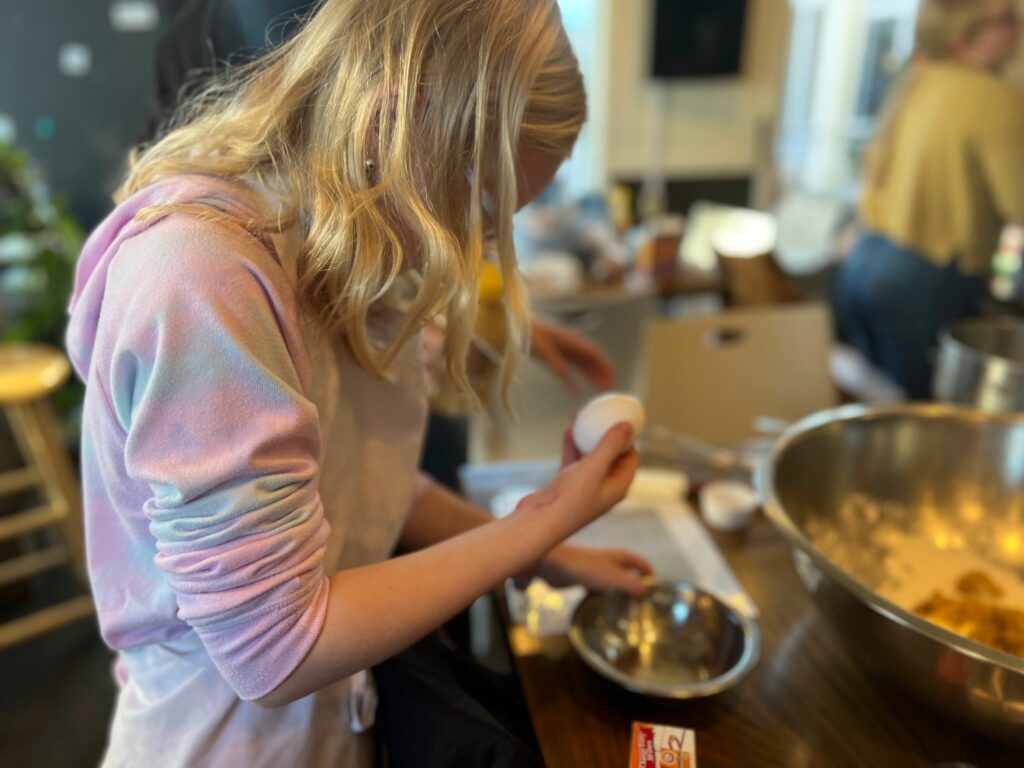 child preparing to crack an egg
