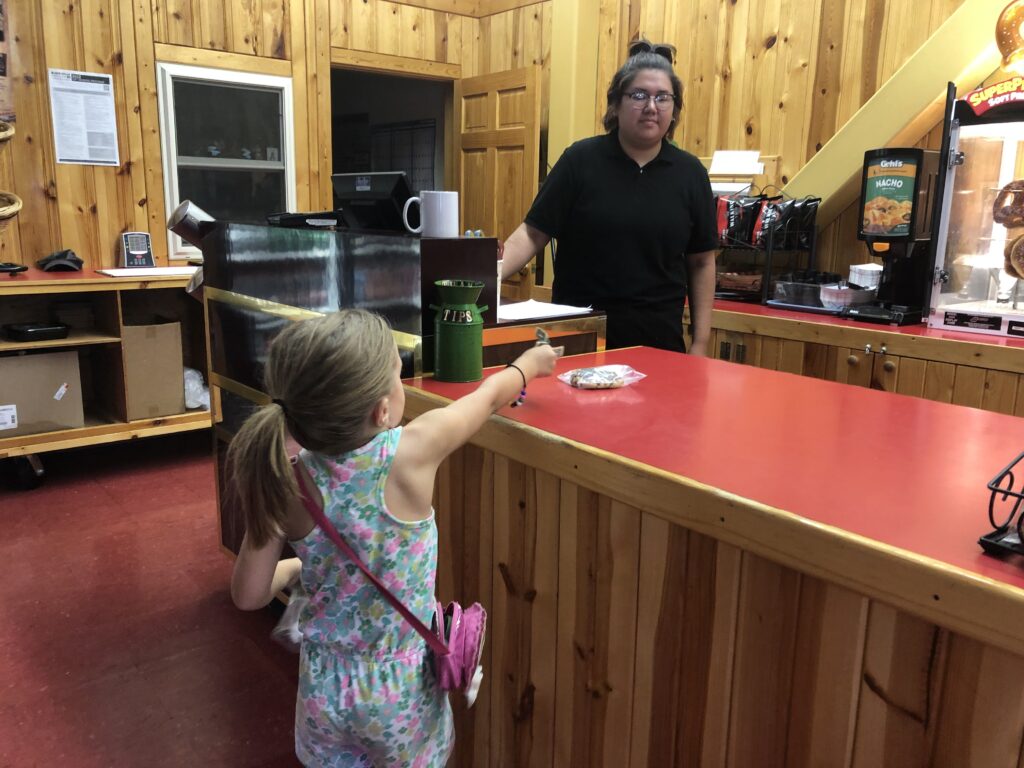 Child paying for items at a snack bar